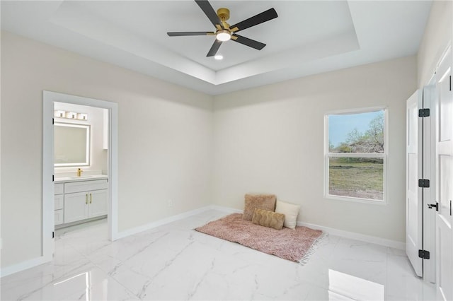 sitting room featuring marble finish floor, a ceiling fan, a tray ceiling, recessed lighting, and baseboards