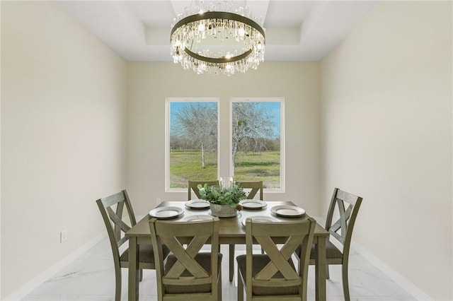 dining room featuring baseboards, marble finish floor, and a chandelier