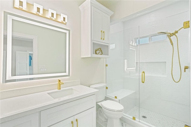 full bath with vanity, a shower stall, and toilet