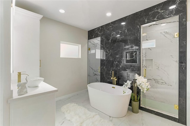 bathroom featuring a marble finish shower, recessed lighting, marble finish floor, and a freestanding bath