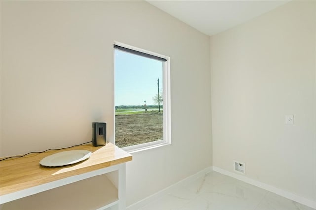 bathroom with baseboards and marble finish floor