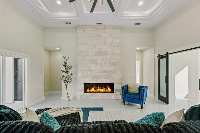 living area with visible vents, a barn door, a fireplace, a towering ceiling, and coffered ceiling