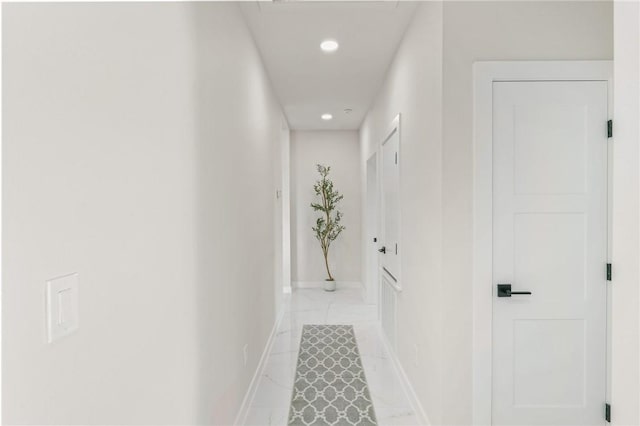 hallway featuring recessed lighting and baseboards