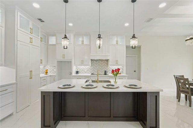 kitchen with recessed lighting, marble finish floor, white cabinets, and light countertops