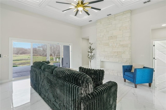 living area with visible vents, coffered ceiling, marble finish floor, and a fireplace