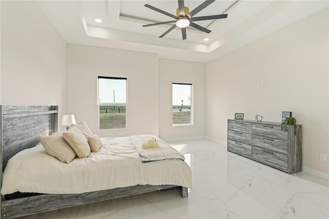 bedroom with marble finish floor, a tray ceiling, recessed lighting, baseboards, and ceiling fan