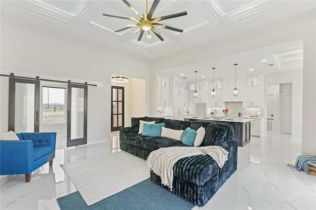 living room featuring marble finish floor, coffered ceiling, a high ceiling, and a barn door