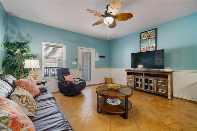 living room with ceiling fan and light tile patterned flooring