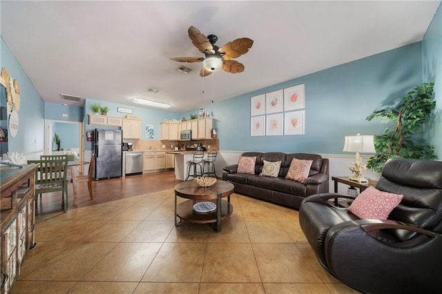 living room featuring ceiling fan and light tile patterned floors