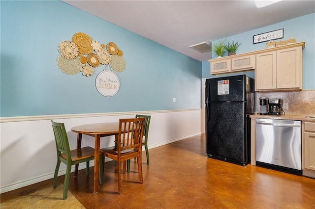 kitchen featuring stainless steel dishwasher, black refrigerator, light brown cabinets, and tasteful backsplash