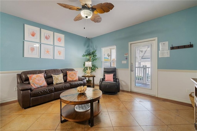 living room with ceiling fan and light tile patterned floors