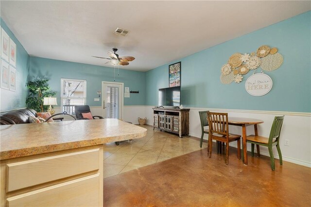 interior space featuring light tile patterned floors and ceiling fan