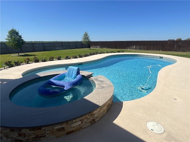 view of swimming pool with a lawn, a pool with connected hot tub, and a fenced backyard