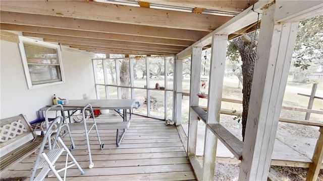 sunroom featuring a wealth of natural light and vaulted ceiling