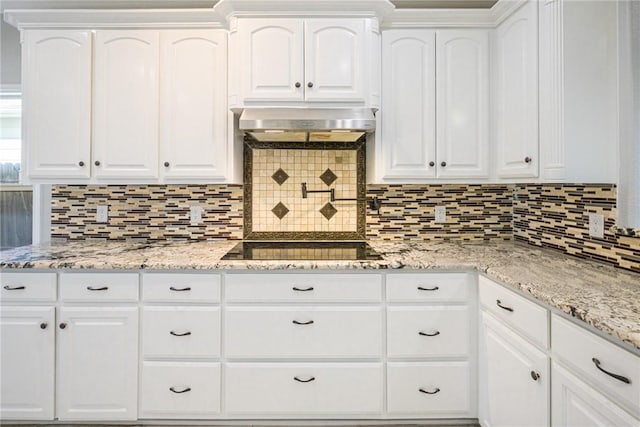 kitchen featuring white cabinetry, tasteful backsplash, and exhaust hood