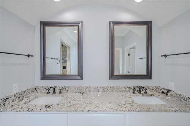 bathroom featuring vanity and vaulted ceiling