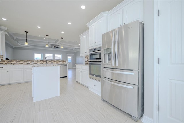 kitchen featuring pendant lighting, a center island, white cabinets, and appliances with stainless steel finishes