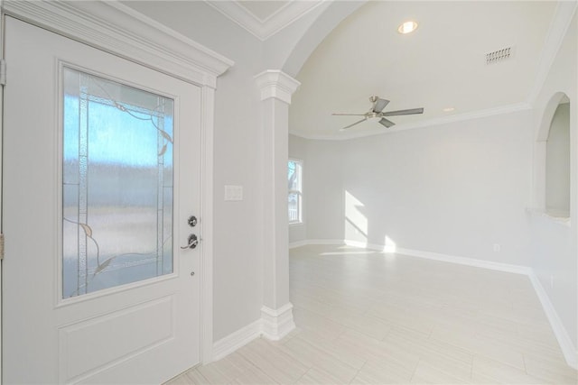 entryway featuring ornamental molding, ceiling fan, and ornate columns