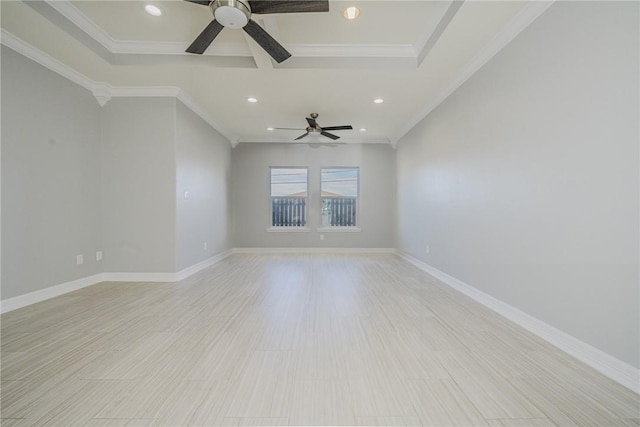 spare room featuring ornamental molding, light hardwood / wood-style flooring, ceiling fan, and a tray ceiling