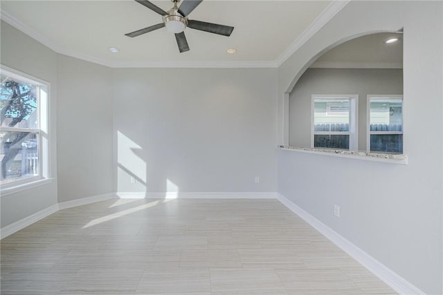 spare room featuring crown molding and ceiling fan