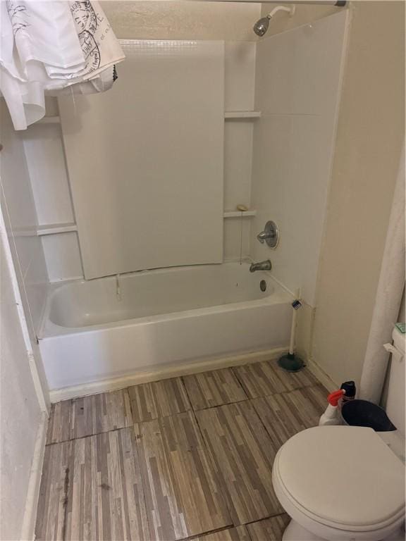 bathroom with toilet and bathtub / shower combination