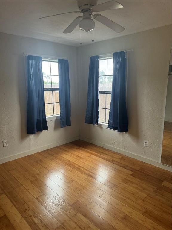 unfurnished room with ceiling fan and light hardwood / wood-style flooring