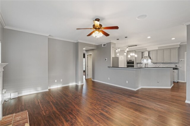 7705 Jacinto, Corpus Christi, TX 78413 - unfurnished living room with a ceiling fan, dark wood-type flooring, ornamental molding, and recessed lighting