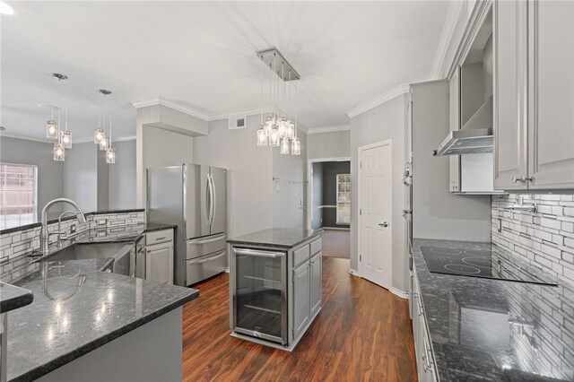 7705 Jacinto, Corpus Christi, TX 78413 - kitchen with beverage cooler, freestanding refrigerator, a center island, gray cabinets, and backsplash
