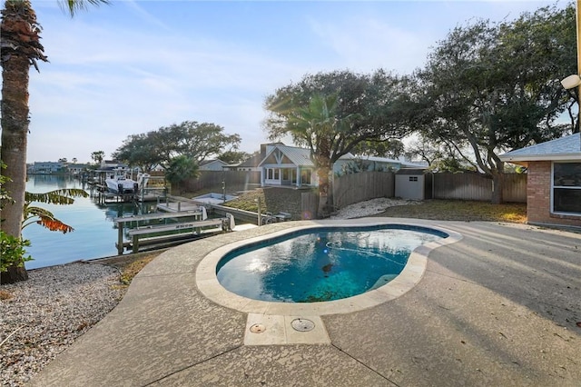 view of pool with a water view and a boat dock