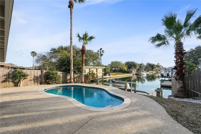 view of pool with a water view and a boat dock