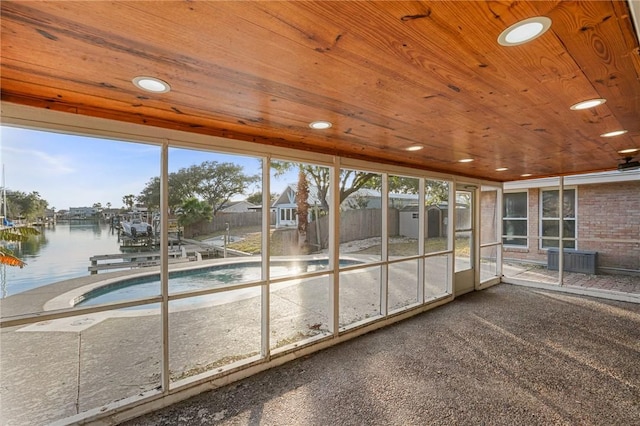 unfurnished sunroom with wooden ceiling and a water view