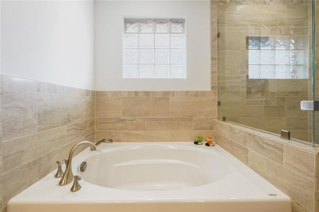 bathroom with a tub to relax in