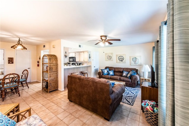 living room featuring ceiling fan and light tile patterned floors