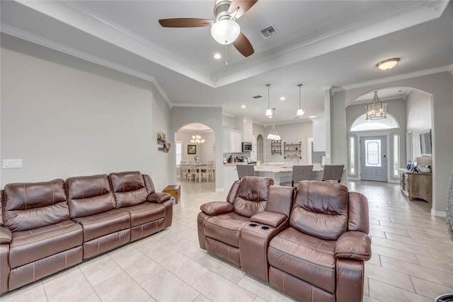 4009 Yankees Pl, Corpus Christi, TX 78414 - living area with arched walkways, a ceiling fan, a tray ceiling, a chandelier, and light tile patterned flooring