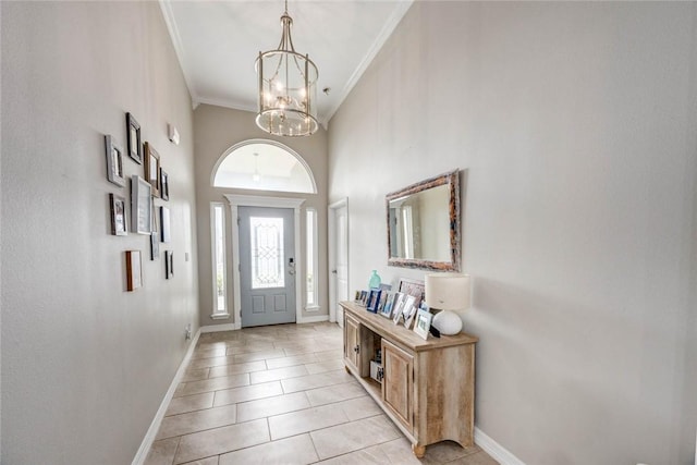 4009 Yankees Pl, Corpus Christi, TX 78414 - entryway with baseboards, ornamental molding, a chandelier, a high ceiling, and light tile patterned floors