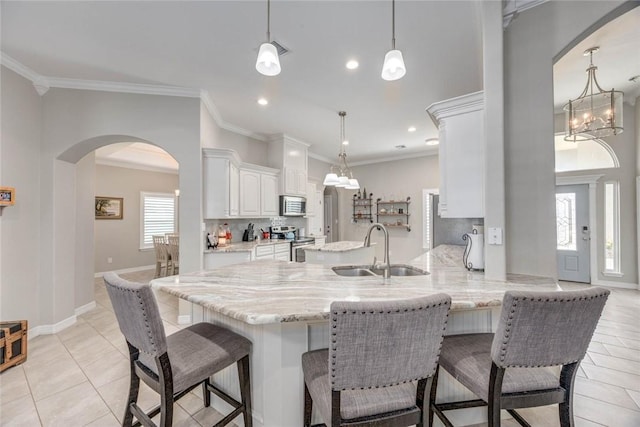4009 Yankees Pl, Corpus Christi, TX 78414 - kitchen with appliances with stainless steel finishes, a sink, a chandelier, arched walkways, and light tile patterned flooring
