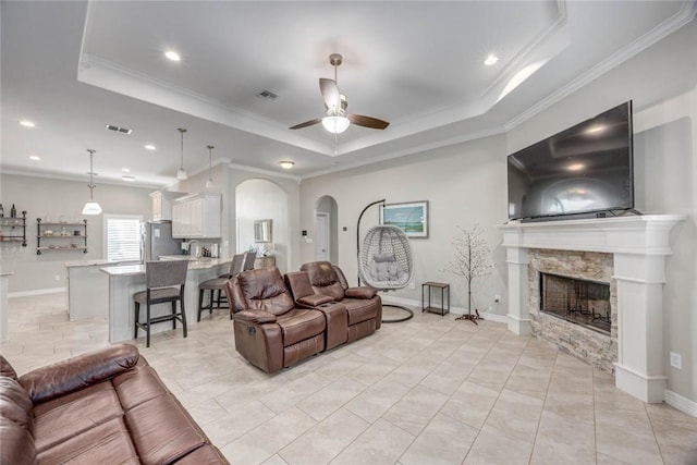 4009 Yankees Pl, Corpus Christi, TX 78414 - living room featuring a tray ceiling, crown molding, ceiling fan, arched walkways, and recessed lighting