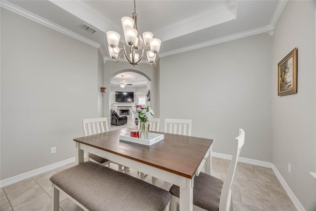 4009 Yankees Pl, Corpus Christi, TX 78414 - dining room featuring arched walkways, ornamental molding, a chandelier, baseboards, and a fireplace