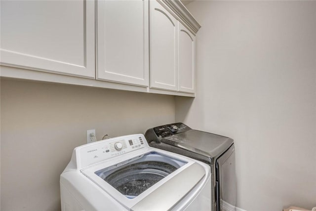 4009 Yankees Pl, Corpus Christi, TX 78414 - washroom with washing machine and clothes dryer and cabinet space