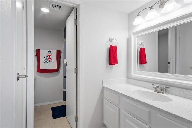 bathroom featuring tile patterned flooring and vanity