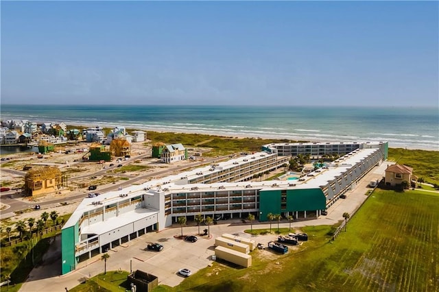 birds eye view of property with a beach view and a water view