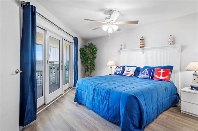 bedroom featuring hardwood / wood-style floors, access to outside, ceiling fan, and vaulted ceiling