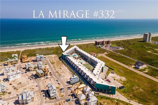 drone / aerial view featuring a water view and a beach view