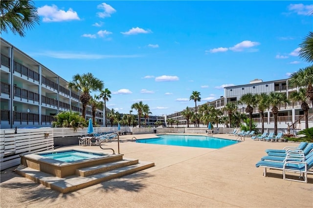 view of pool featuring a community hot tub and a patio