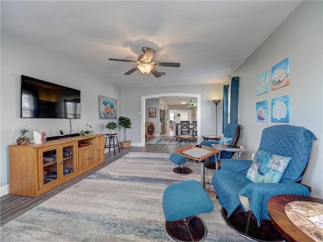 341 W Greenwood Ave, Aransas Pass, TX 78336 - living room with wood finished floors, arched walkways, baseboards, and ceiling fan