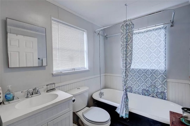341 W Greenwood Ave, Aransas Pass, TX 78336 - full bathroom featuring a wainscoted wall, vanity, toilet, and shower / bathtub combination with curtain