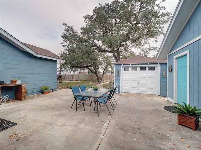 341 W Greenwood Ave, Aransas Pass, TX 78336 - view of patio / terrace featuring outdoor dining space, concrete driveway, and a garage