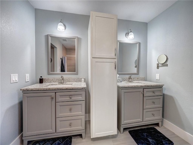 341 W Greenwood Ave, Aransas Pass, TX 78336 - bathroom with baseboards, two vanities, and curtained shower