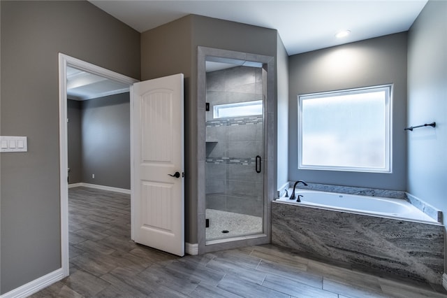 bathroom with wood-type flooring and plus walk in shower