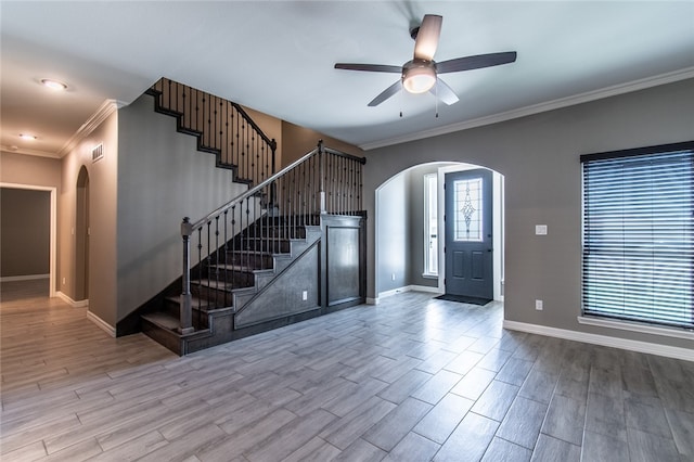 entrance foyer featuring ceiling fan, ornamental molding, and light hardwood / wood-style flooring